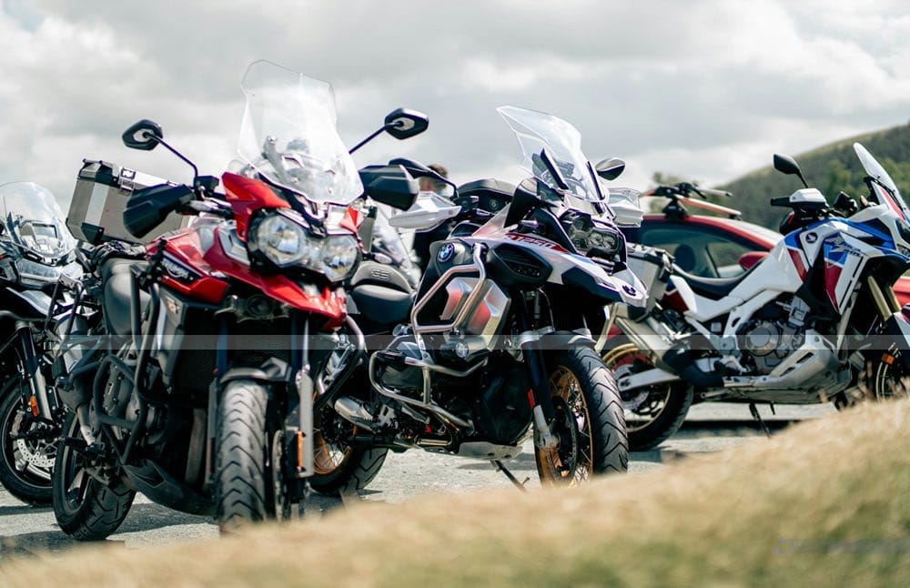Line-up of adventure motorcycles parked side by side for a returning rider comparing options